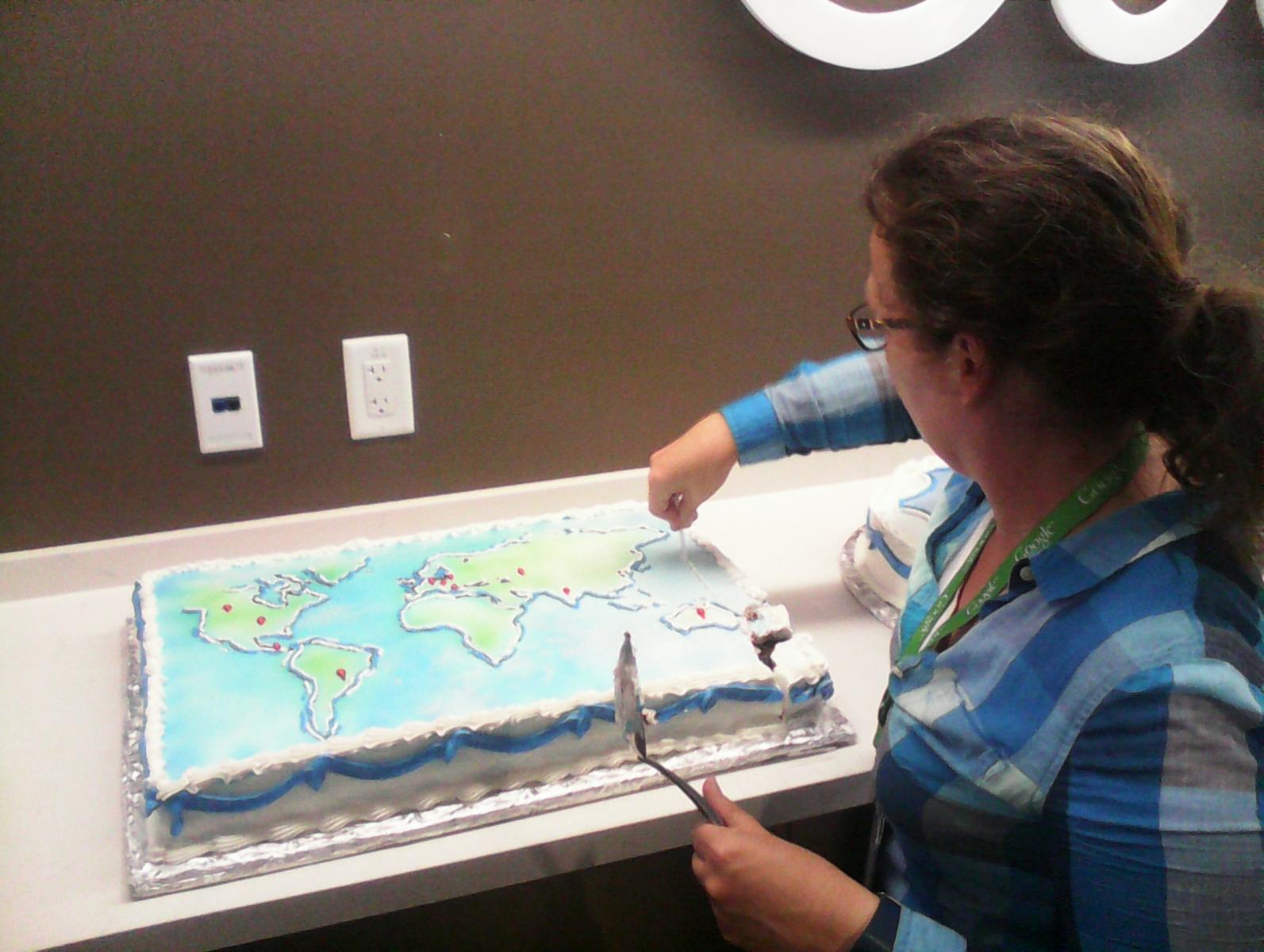 Stephanie cutting the map cake